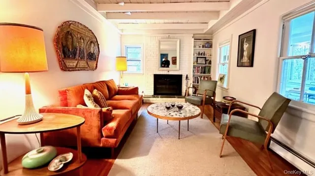 a living room with fireplace furniture and a wooden floor