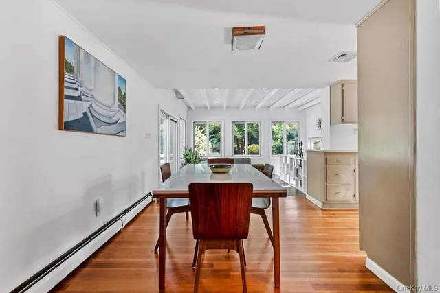 a dining room with furniture and wooden floor