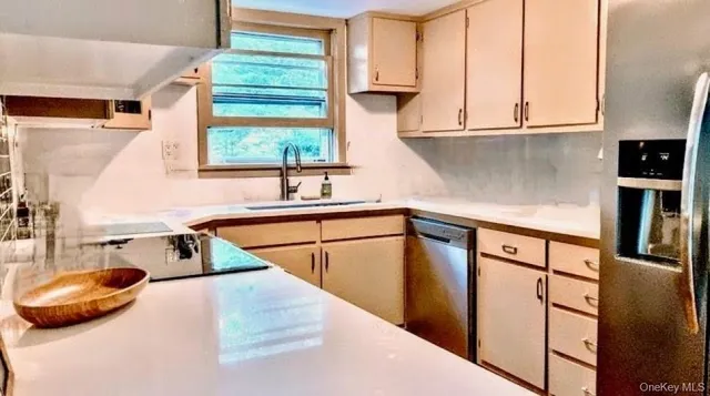 a kitchen with stainless steel appliances granite countertop a sink and a microwave