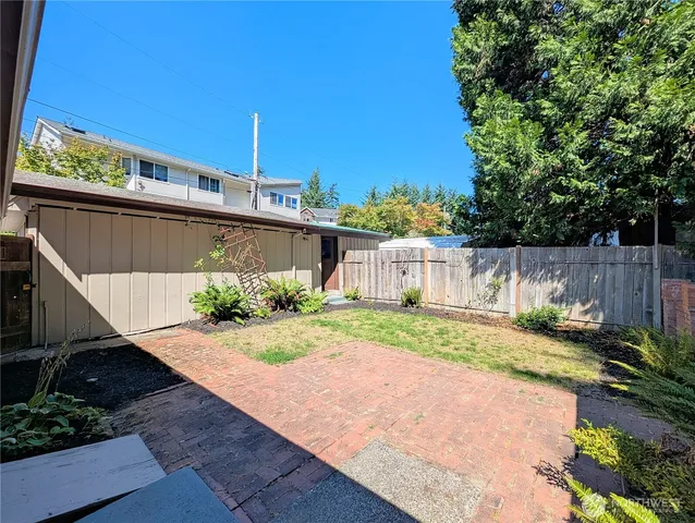 a view of a backyard with wooden fence