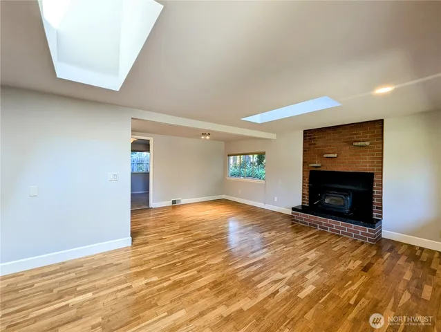 a view of empty room with a fireplace