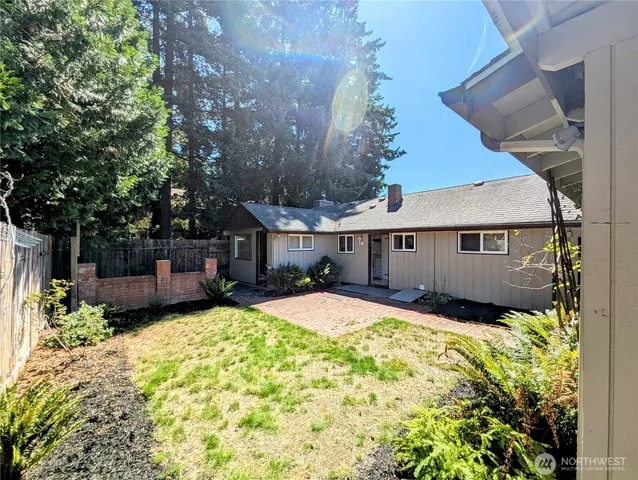 a view of a house with a yard and tree s