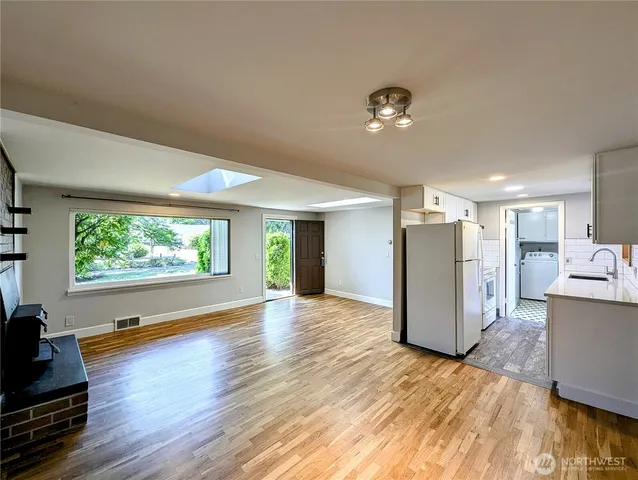 a view of a livingroom with furniture hardwood floor and a window