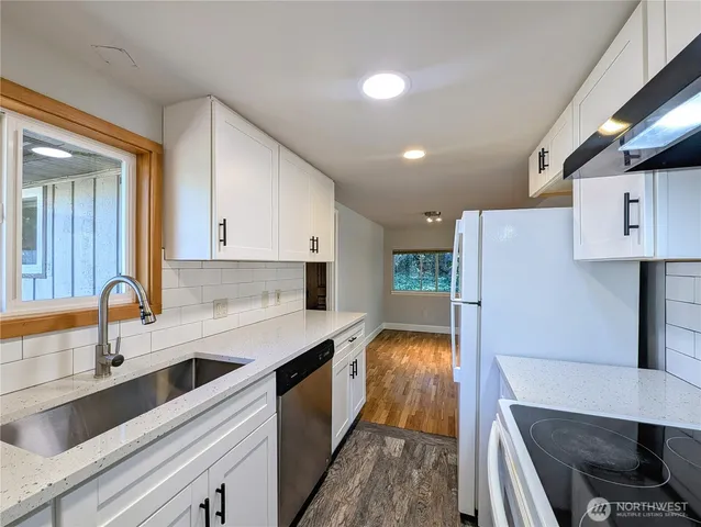 a kitchen with a sink stove and refrigerator