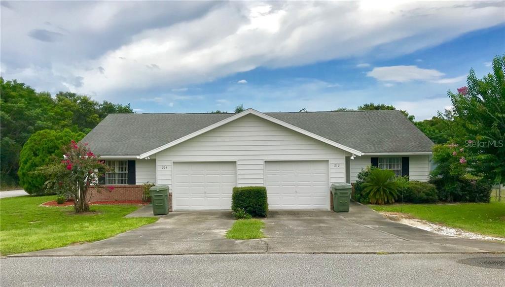 214 Fernwood Street Leesburg, FL 34748 - Photo 1 of 1 a front view of house with yard and green space