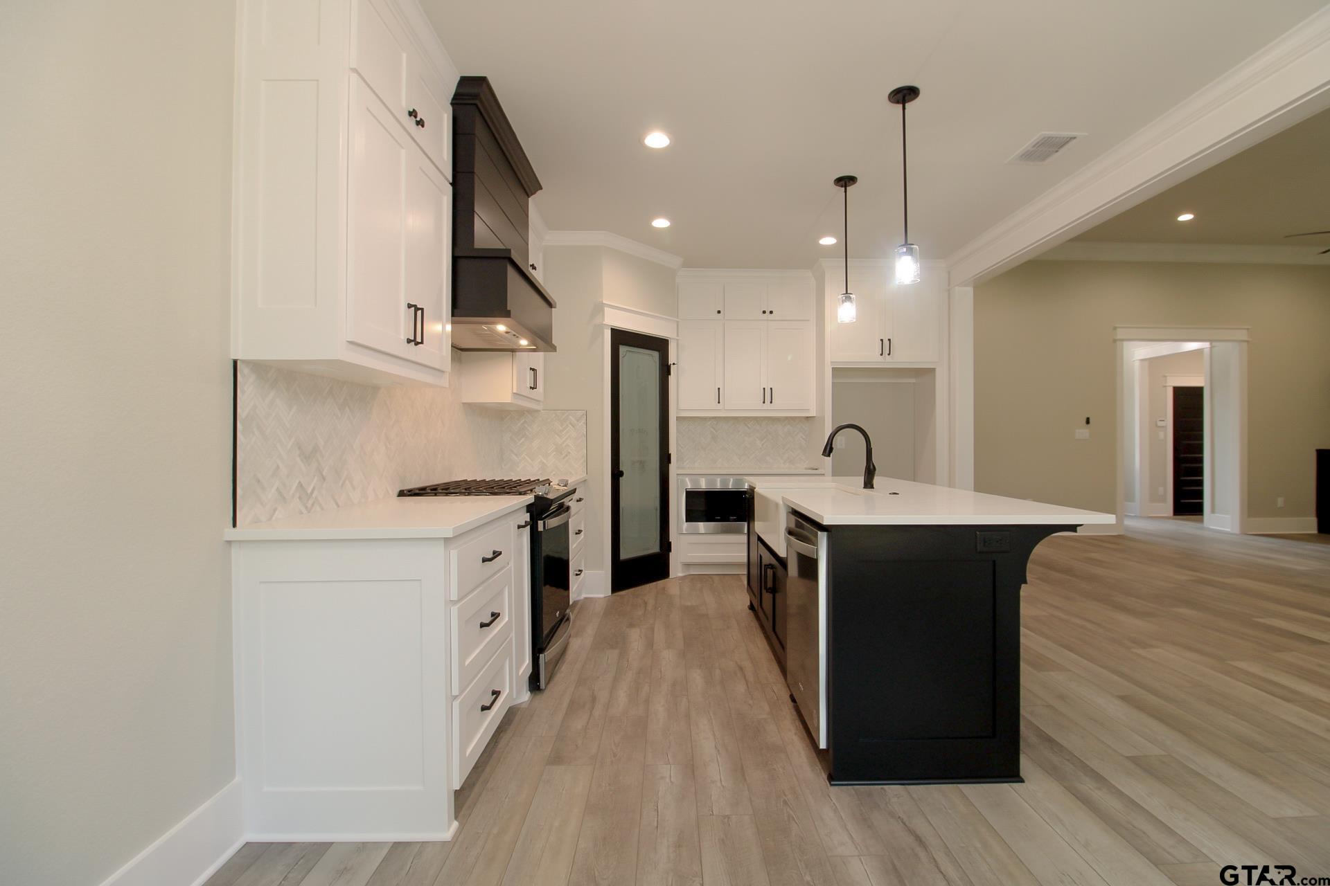 1069 Stagecoach Bend Bullard, TX 75757 - Photo 13 of 44 a open kitchen with stainless steel appliances granite countertop a sink a stove and a refrigerator