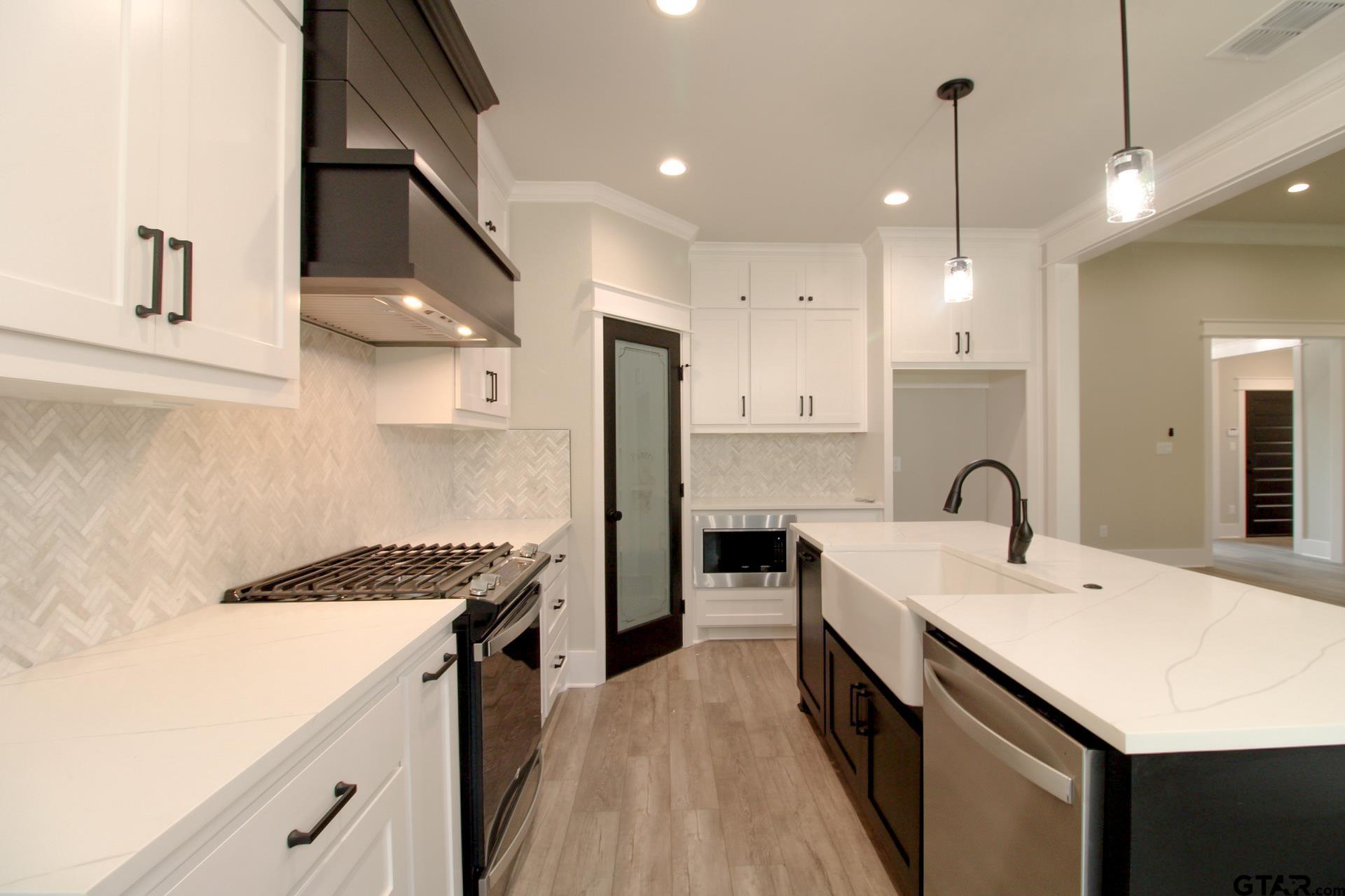 1069 Stagecoach Bend Bullard, TX 75757 - Photo 14 of 44 a kitchen with a sink stove and refrigerator
