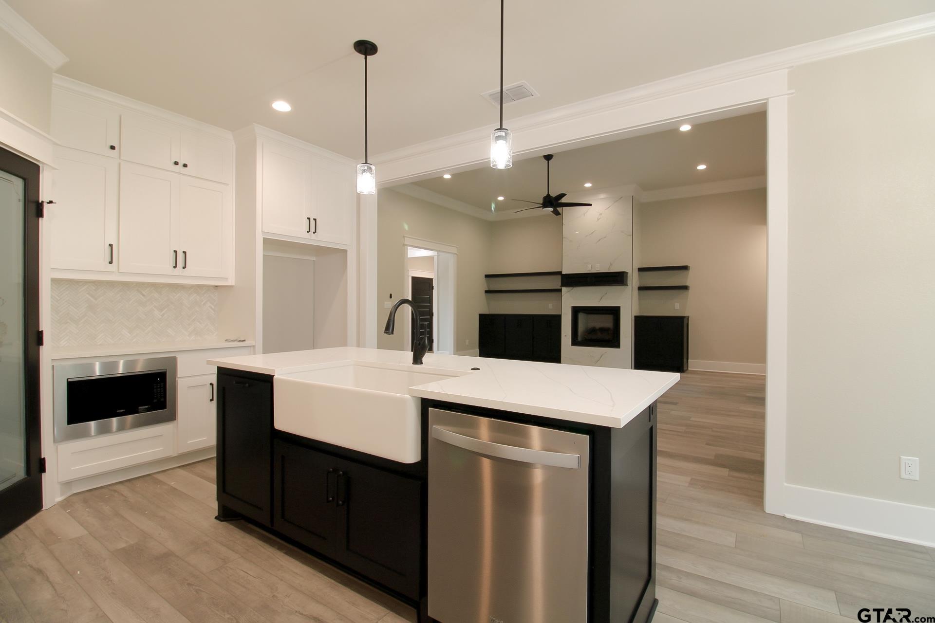 1069 Stagecoach Bend Bullard, TX 75757 - Photo 17 of 44 a large room with kitchen view and a fireplace