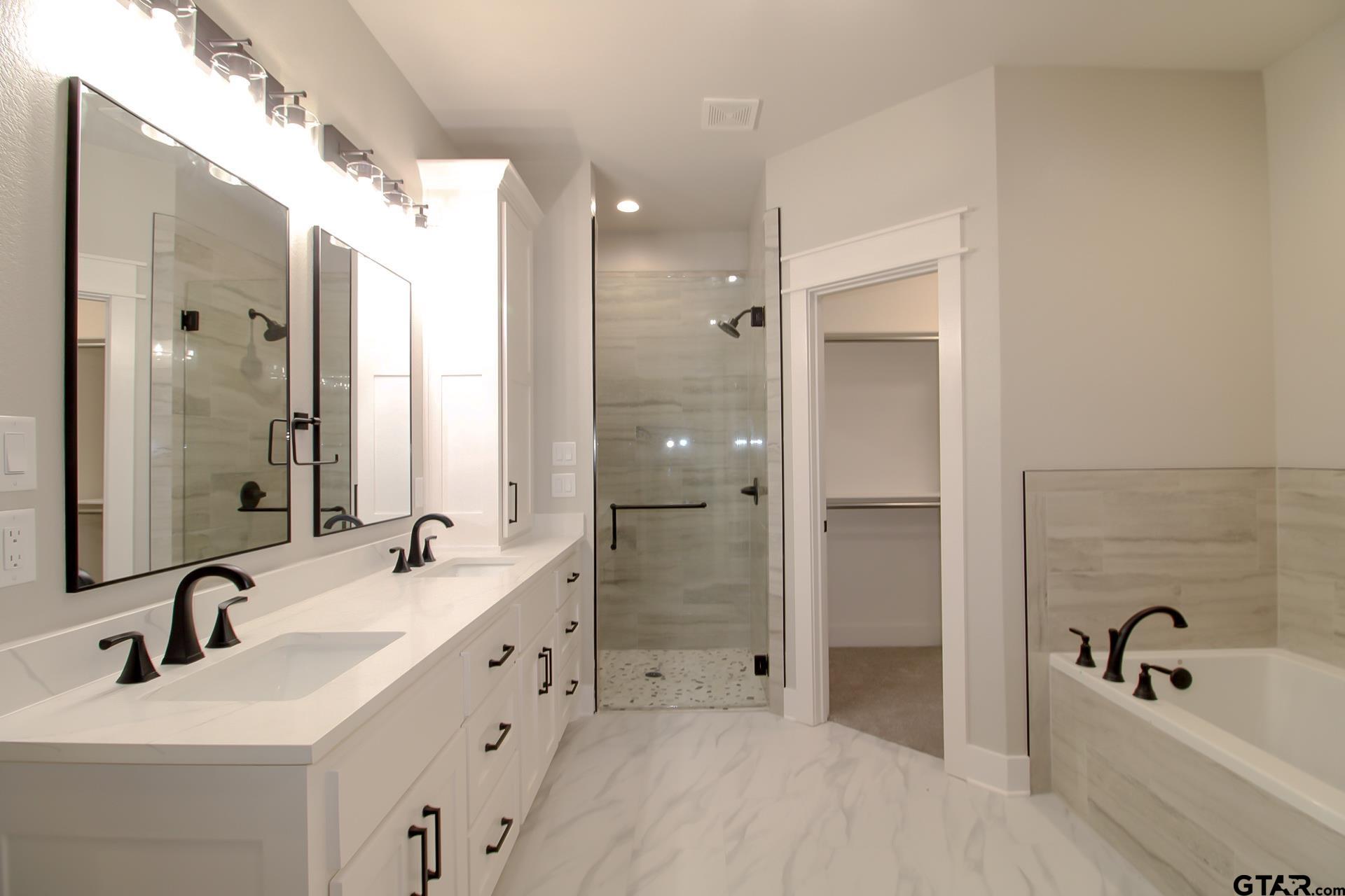 1069 Stagecoach Bend Bullard, TX 75757 - Photo 21 of 44 a bathroom with a tub sink double and mirror
