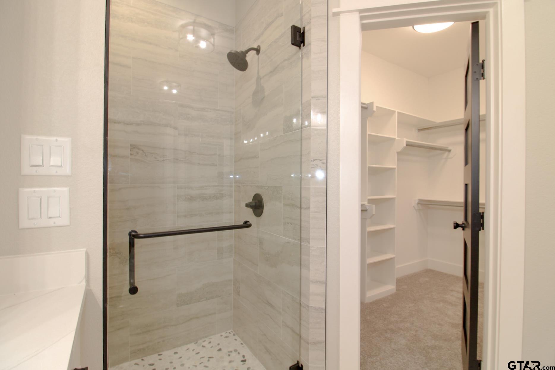 1069 Stagecoach Bend Bullard, TX 75757 - Photo 24 of 44 a bathroom with a glass shower door