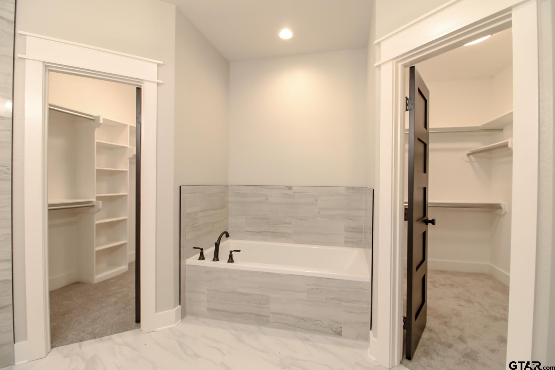 1069 Stagecoach Bend Bullard, TX 75757 - Photo 25 of 44 a bathroom with a bathtub and a glass door shower