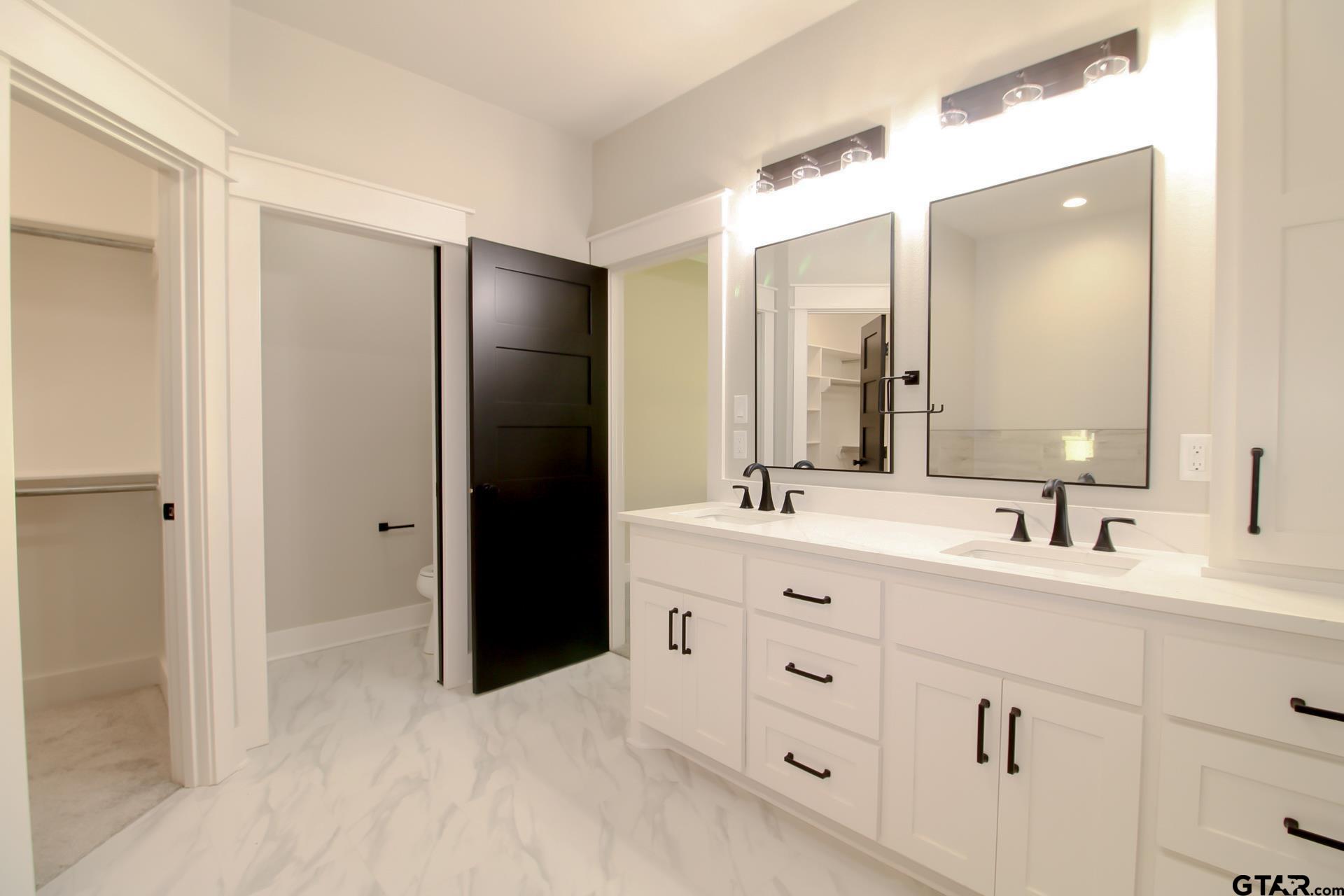 1069 Stagecoach Bend Bullard, TX 75757 - Photo 26 of 44 a bathroom with a double vanity sink and mirror
