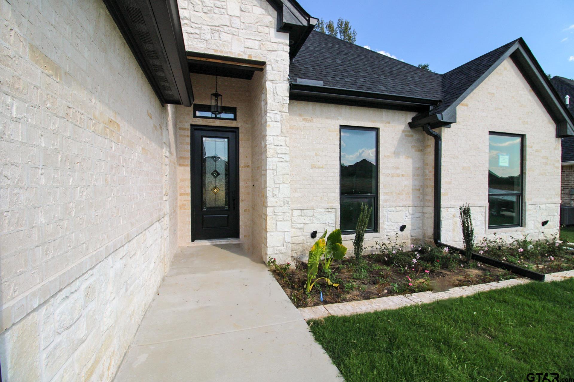 1069 Stagecoach Bend Bullard, TX 75757 - Photo 3 of 44 a front view of a house with garden