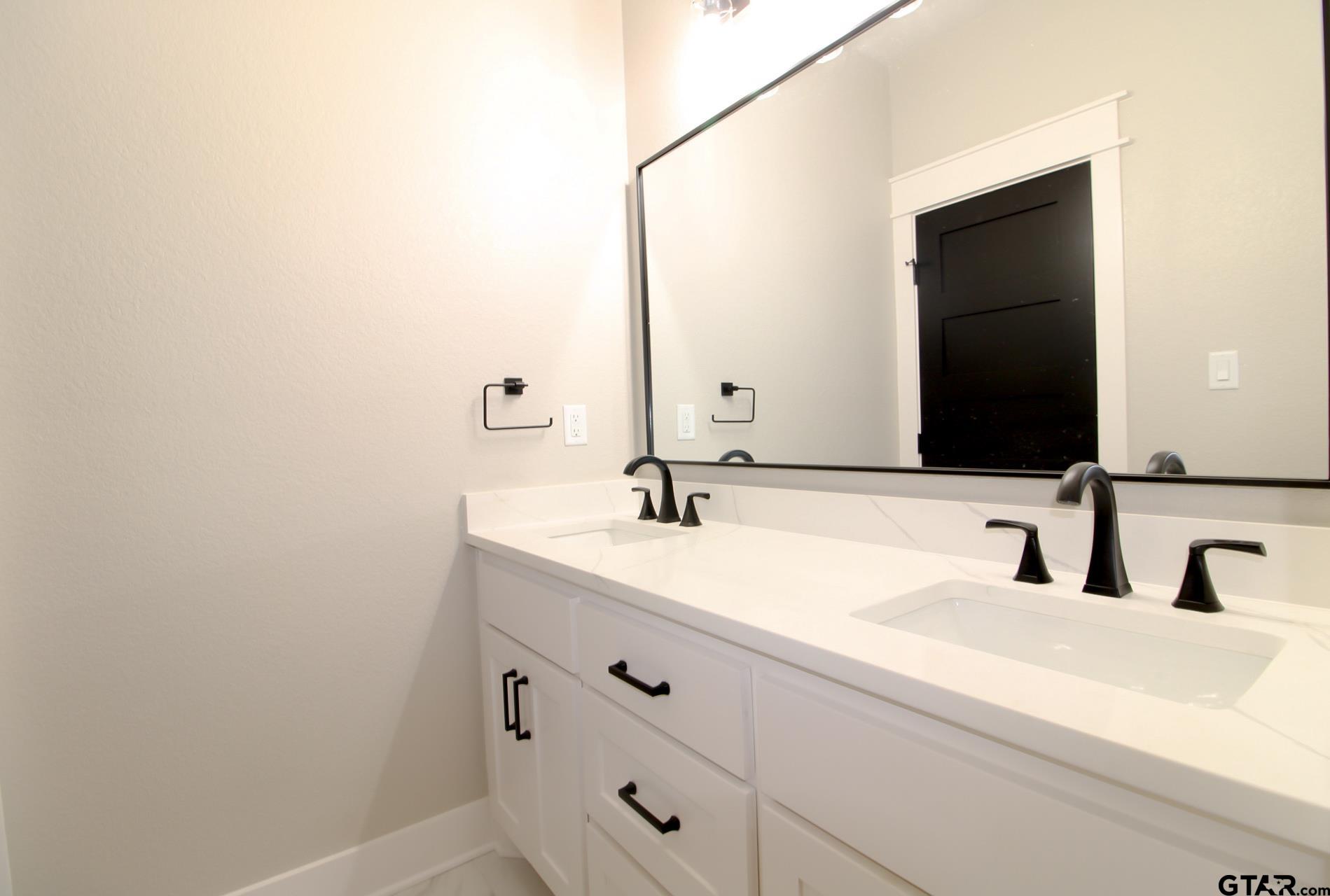 1069 Stagecoach Bend Bullard, TX 75757 - Photo 35 of 44 a bathroom with a sink and a mirror
