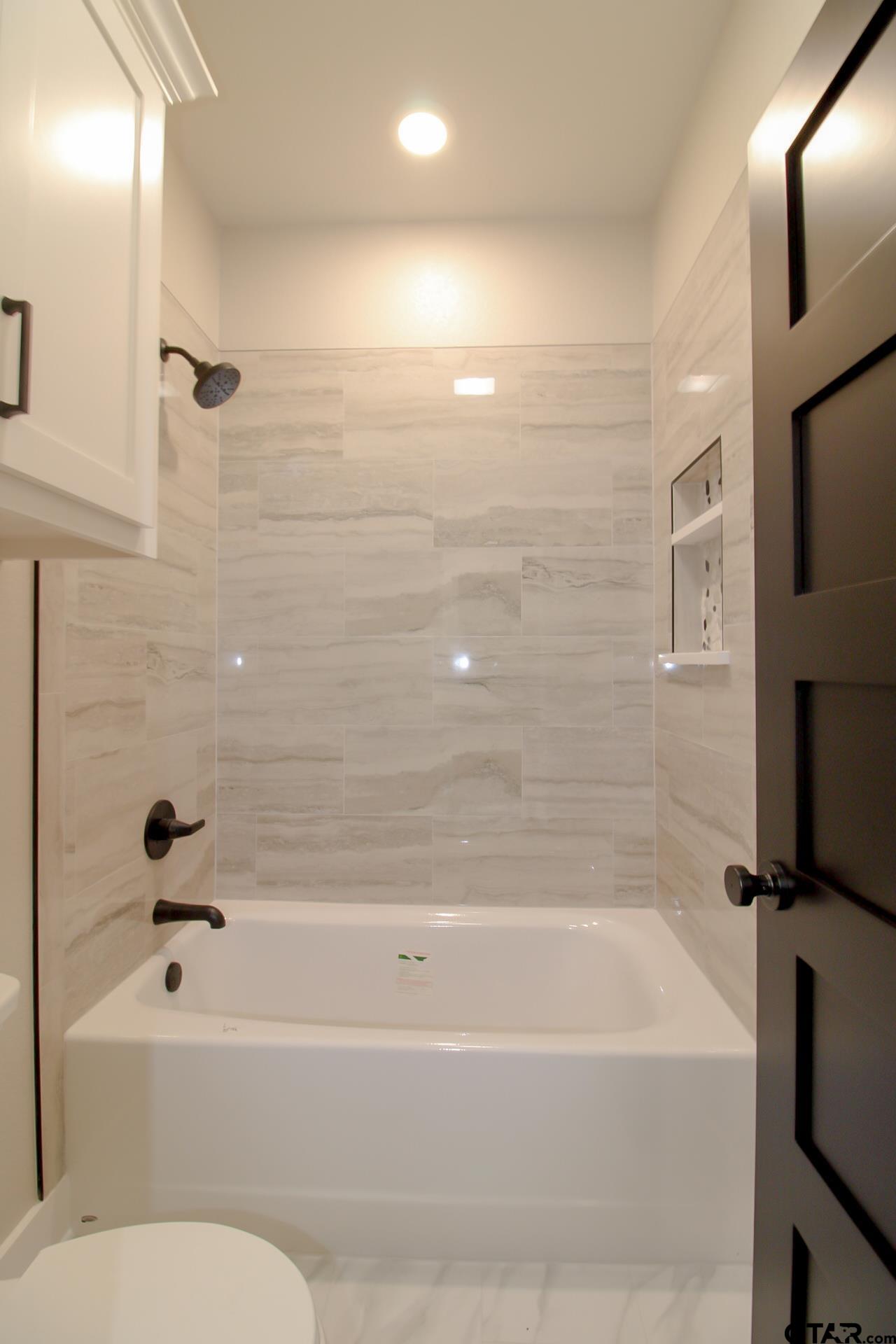 1069 Stagecoach Bend Bullard, TX 75757 - Photo 36 of 44 a bathroom with a bathtub and a shower