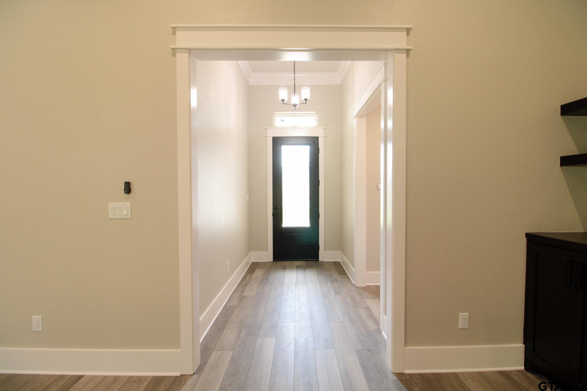 1069 Stagecoach Bend Bullard, TX 75757 - Photo 4 of 44 a view of a room with wooden floor and a bathroom