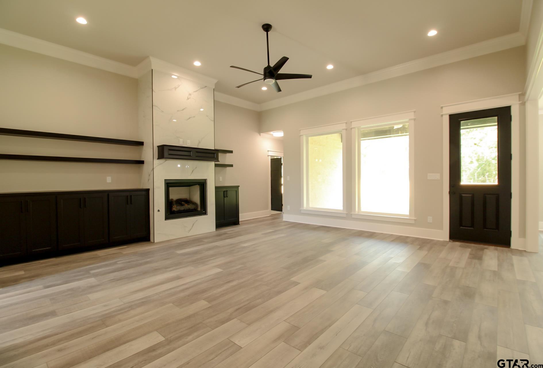 1069 Stagecoach Bend Bullard, TX 75757 - Photo 6 of 44 an empty room with windows and cabinet