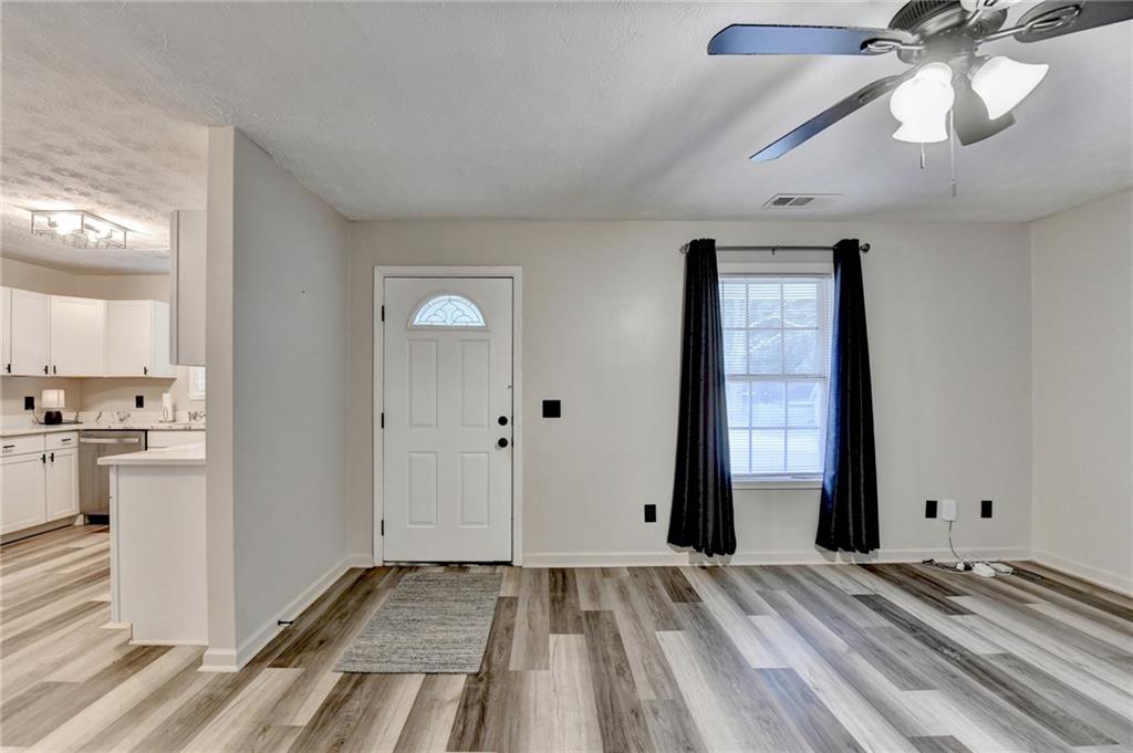 801 Davis Street Monroe, GA 30655 - Photo 4 of 33 a view of a room with wooden floor and white walls