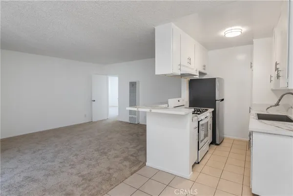 a view of kitchen with microwave and cabinets