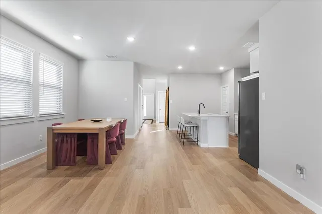 a living room with furniture a wooden floor and a sink