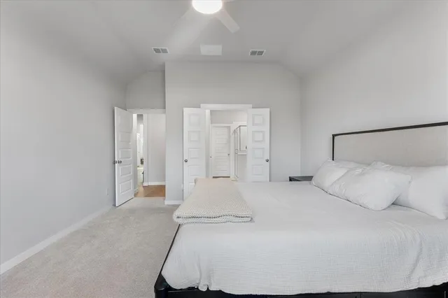 a large white bed in a white room