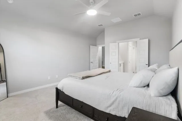 a bedroom with a bed and a night stand