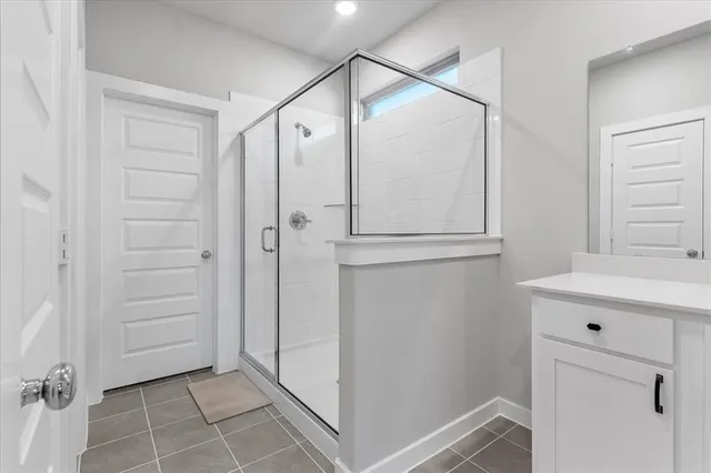a bathroom with a shower and a sink