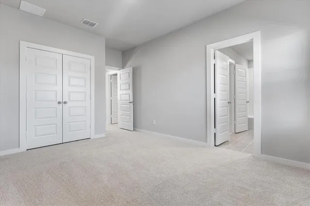 an empty room with closet area