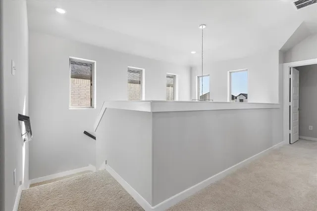 a view of a kitchen from the hallway