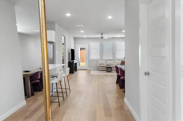 a view of a living room kitchen and a wooden floor