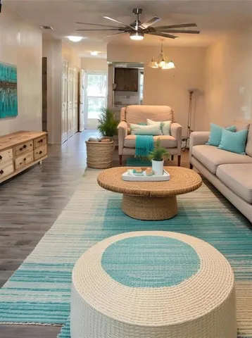 a dining room with furniture a rug and wooden floor