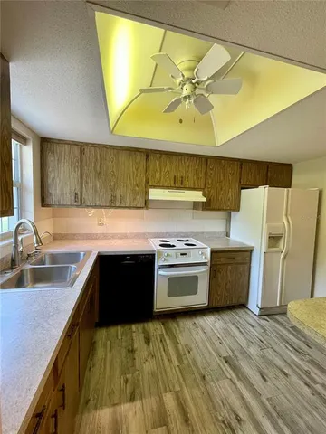 a bathroom with a sink vanity mirror toilet and bathtub