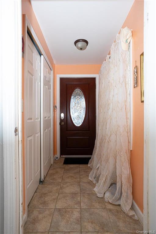 114-11 207th Street Queens, NY 11411 - Photo 2 of 15 Doorway to outside featuring tile patterned flooring