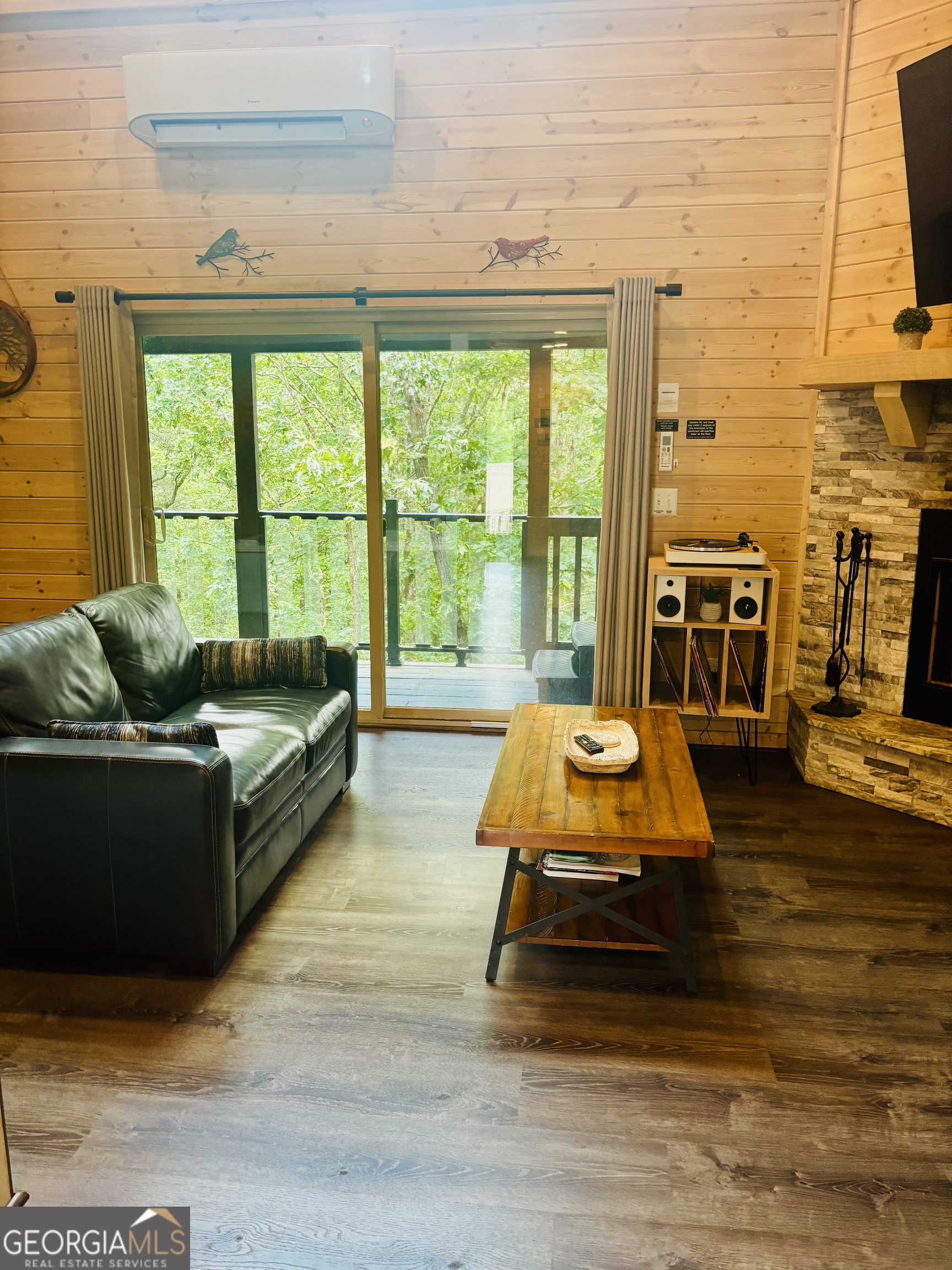 185 Walnut Ridge Drive Cleveland, GA 30528 - Photo 11 of 36 a living room with furniture floor to ceiling window and a flat screen tv