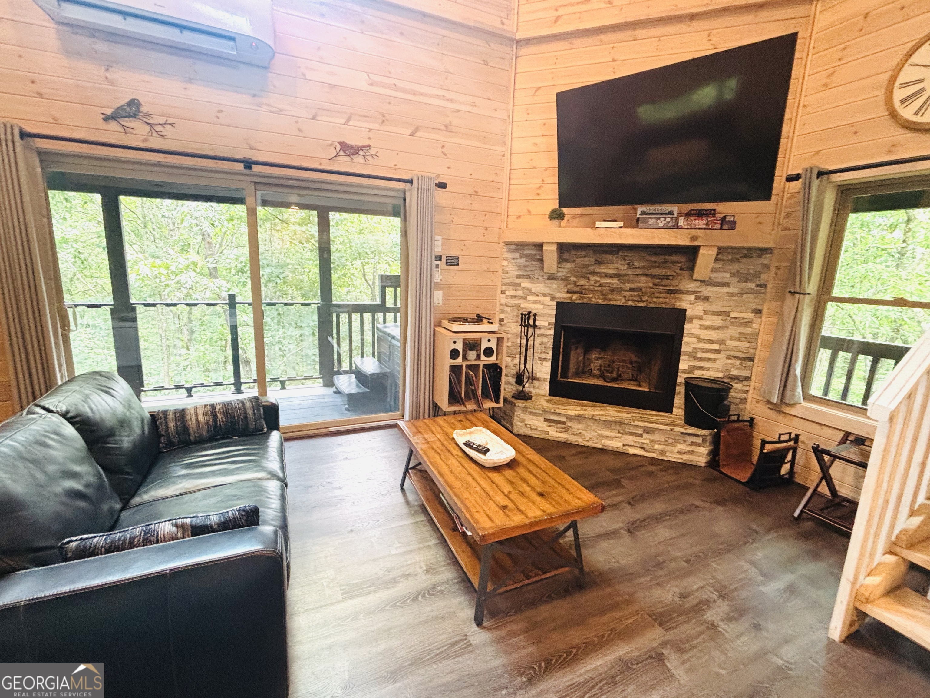 185 Walnut Ridge Drive Cleveland, GA 30528 - Photo 12 of 36 a living room with furniture a flat screen tv and a fireplace