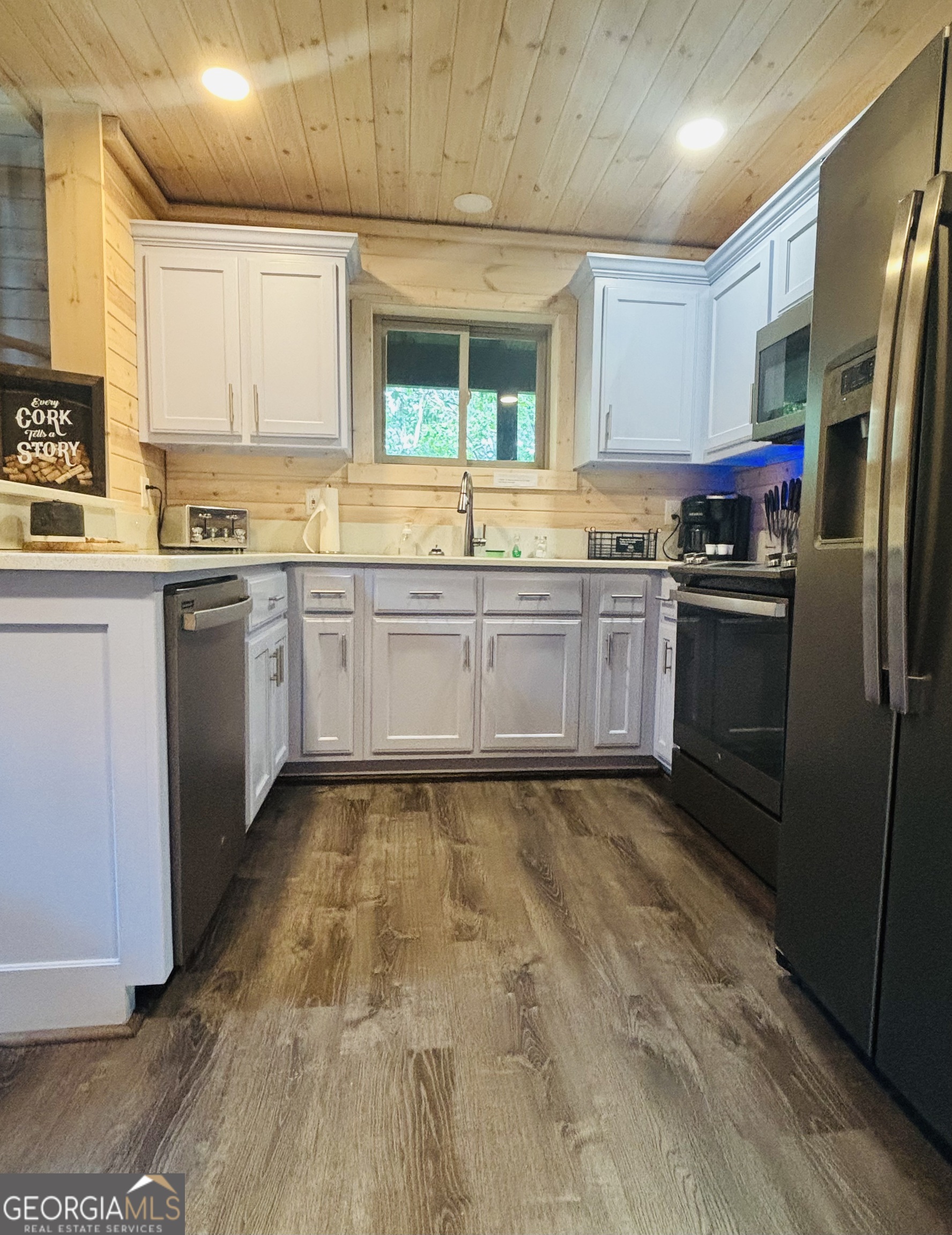 185 Walnut Ridge Drive Cleveland, GA 30528 - Photo 16 of 36 a large kitchen with granite countertop a stove a sink dishwasher and a refrigerator