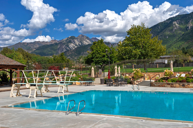 16 Gatehouse Lane Sandy, UT 84092 - Photo 65 of 73 Community pool featuring a patio and a mountain view