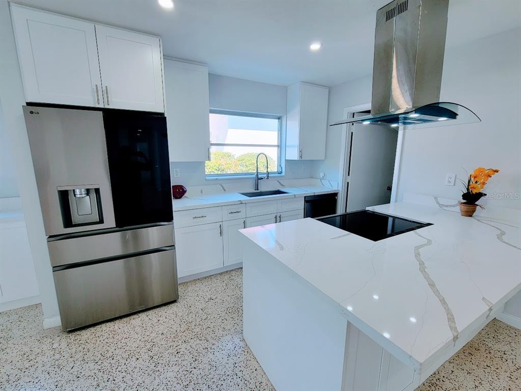 1732 Boca Raton Court Punta Gorda, FL 33950 - Photo 5 of 64 a kitchen with a refrigerator a sink and cabinets