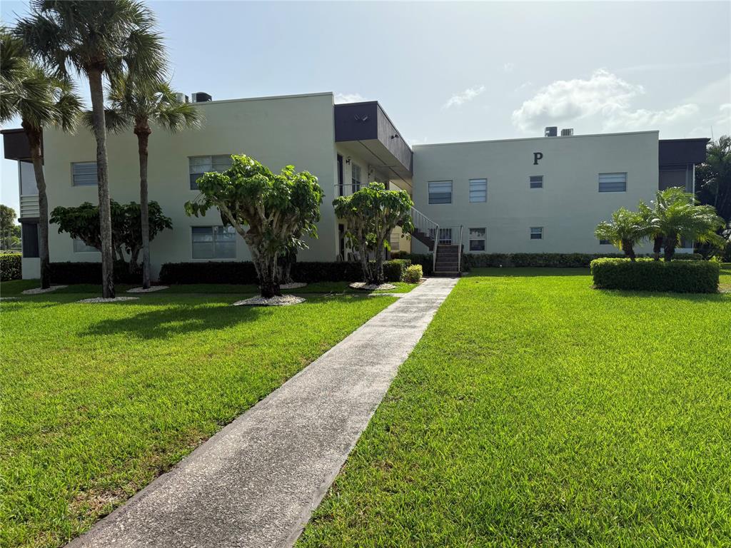 768 P Normandy, Unit 768 Delray Beach, FL 33484 - Photo 13 of 34 a front view of a house with garden