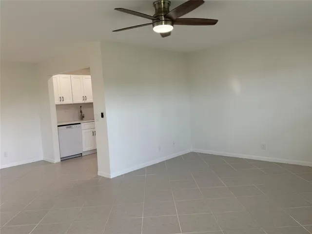 an empty room with a kitchen