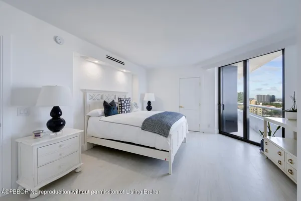 a bed room with a bed and a large mirror