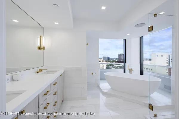 a large white kitchen with a large window