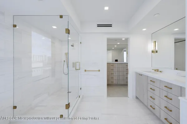 a bathroom with a shower sink and mirror