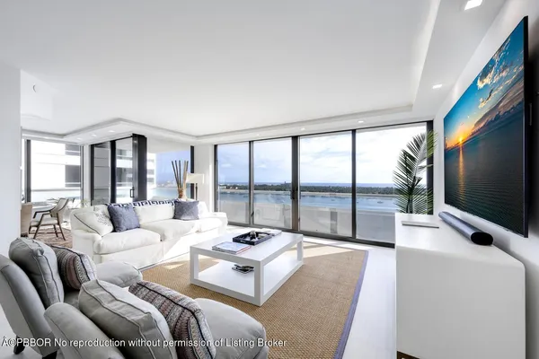 a living room with furniture large window and a flat screen tv