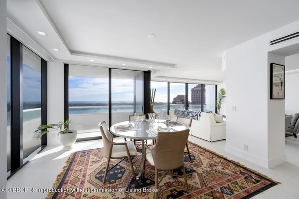 a dining room with furniture wooden floor and a rug