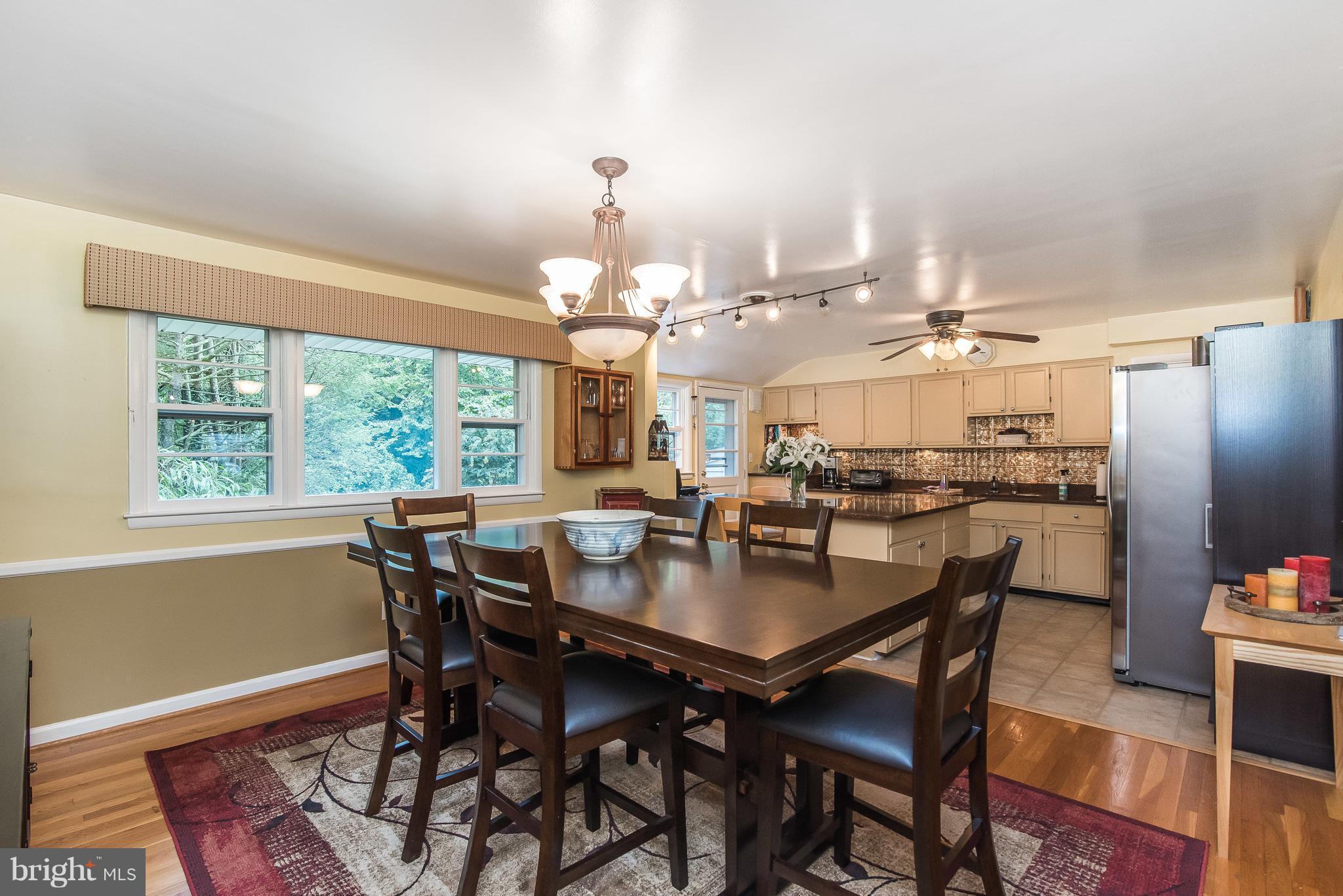 6116 Haddon Hall Road Baltimore, MD 21212 - Photo 12 of 44 a dining room with wooden floor and chandelier