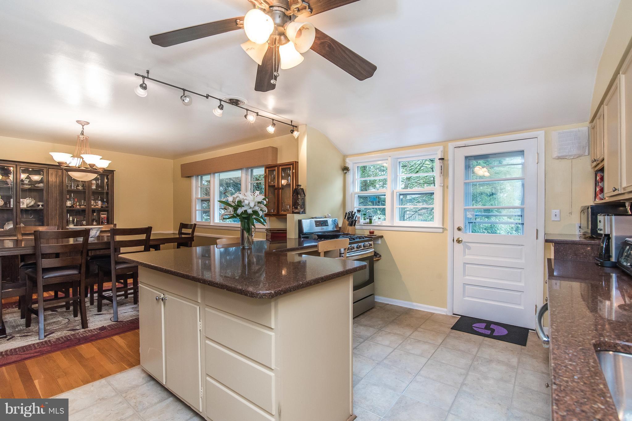 6116 Haddon Hall Road Baltimore, MD 21212 - Photo 15 of 44 a kitchen with a stove a refrigerator and a dining table