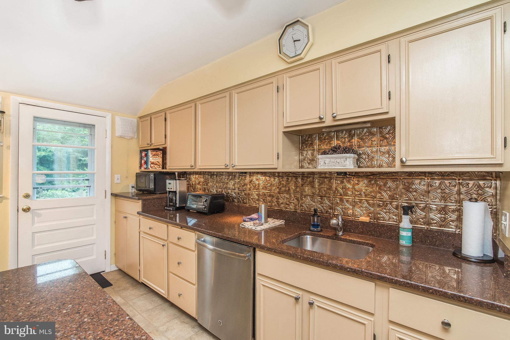 6116 Haddon Hall Road Baltimore, MD 21212 - Photo 16 of 44 a kitchen with granite countertop a sink a stove and cabinets