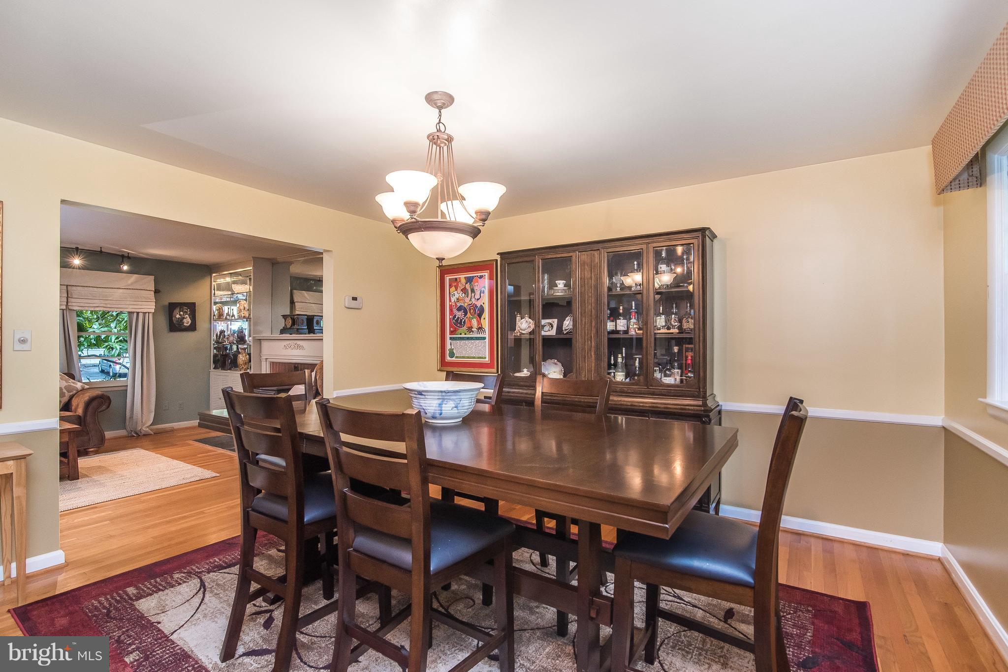 6116 Haddon Hall Road Baltimore, MD 21212 - Photo 17 of 44 a view of a dining room with furniture wooden floor and chandelier