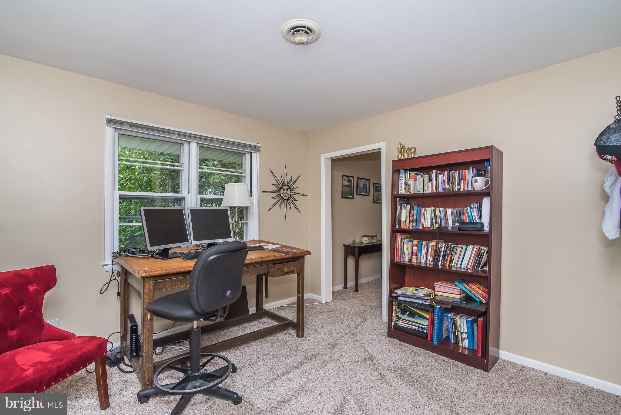6116 Haddon Hall Road Baltimore, MD 21212 - Photo 22 of 44 a view of a workspace with furniture and a bookshelf